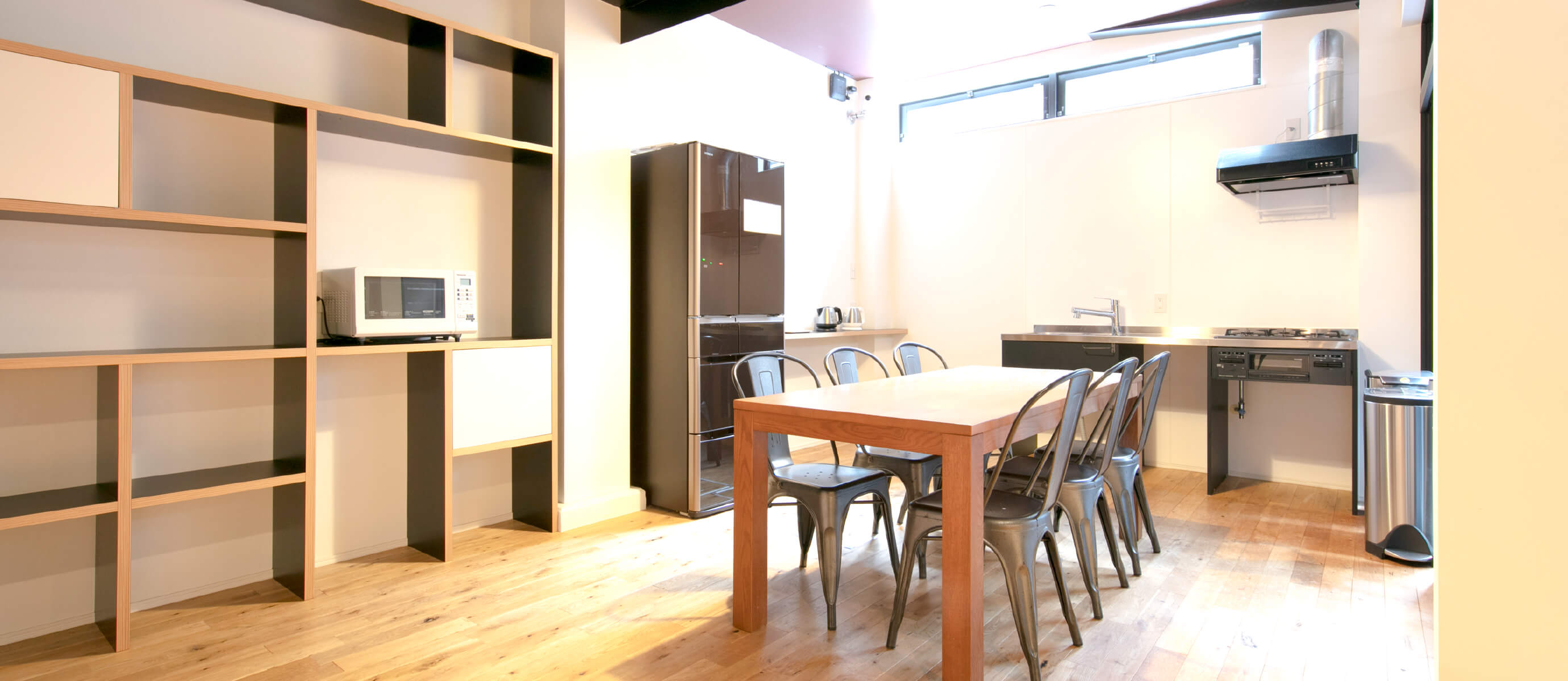 The first floor has a shared dining space, with a refrigerator and simple cooking facilities.